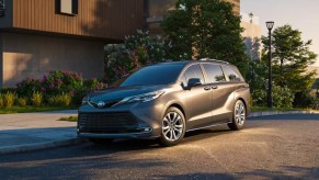 A gray 2022 Toyota SIenna is parked on the road. minivan