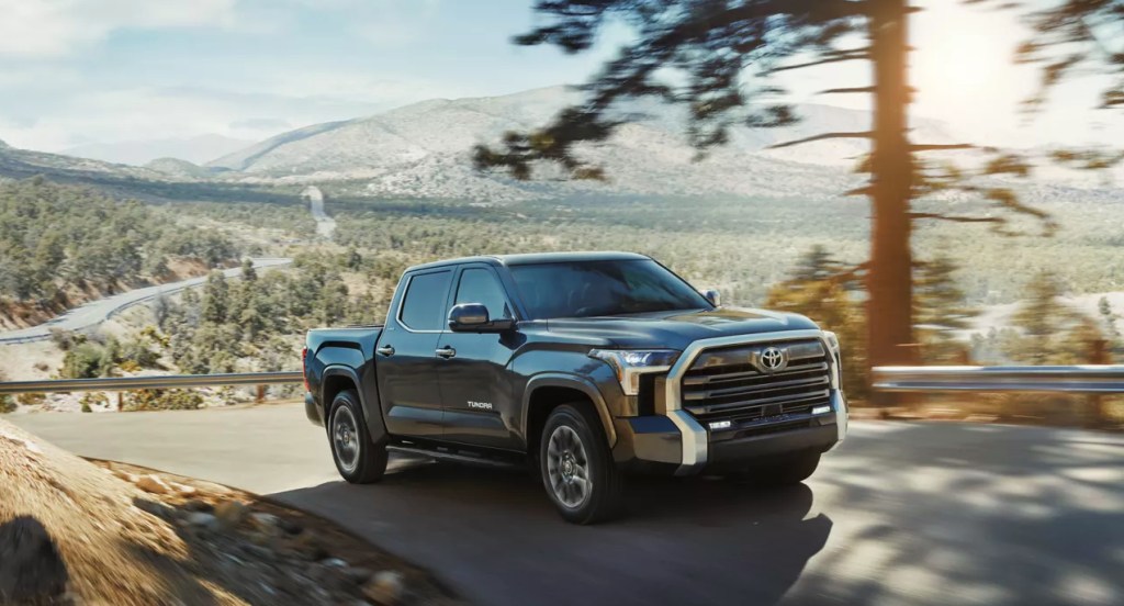 A gray 2022 Toyota Tundra full-size pickup truck is driving on the road. 