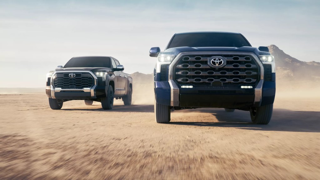 A pair of Toyota Trucks show their capability in a desert terrain.