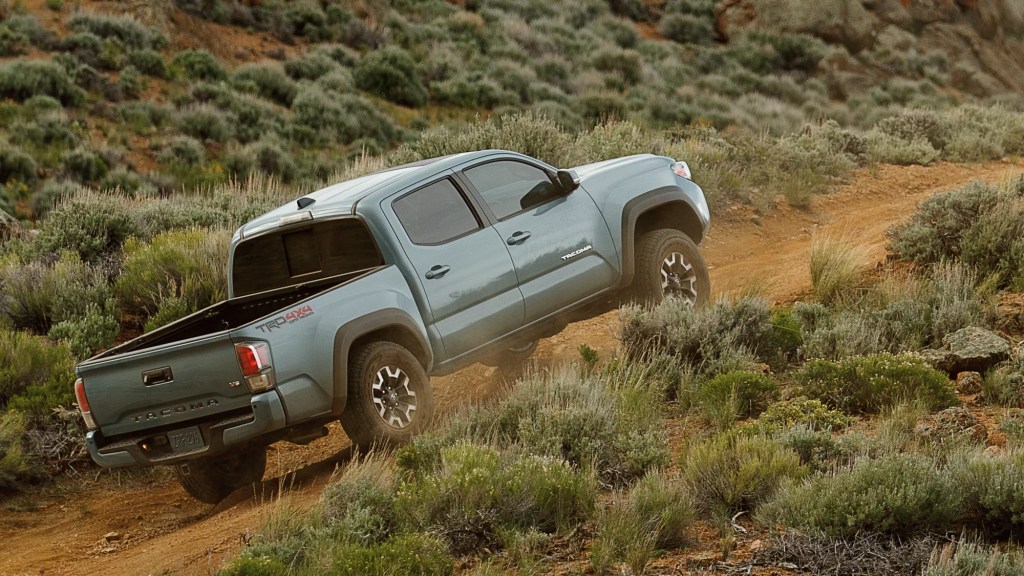 A 2022 Toyota Tacoma navigates on a dirt road showing its off-road capability