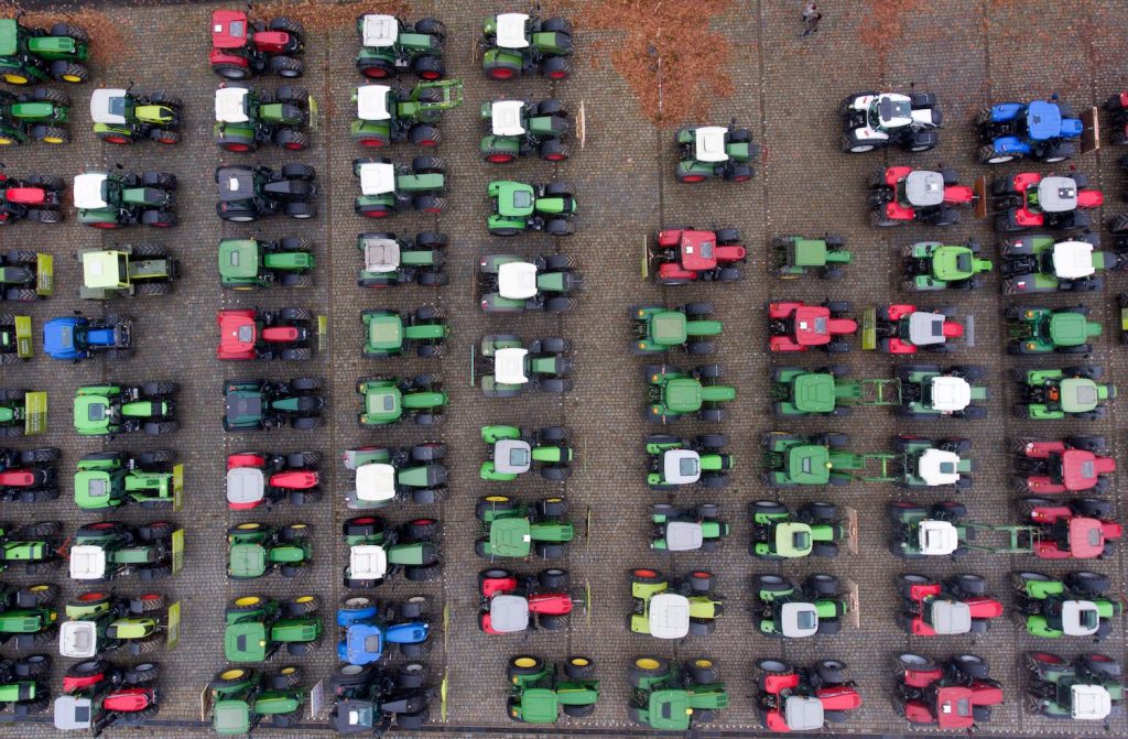 Rows of tractors parked together.