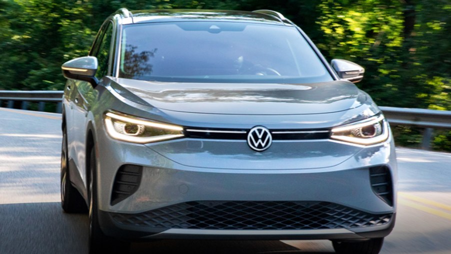 A gray 2022 Volkswagen ID.4 electric SUV is driving on the road.