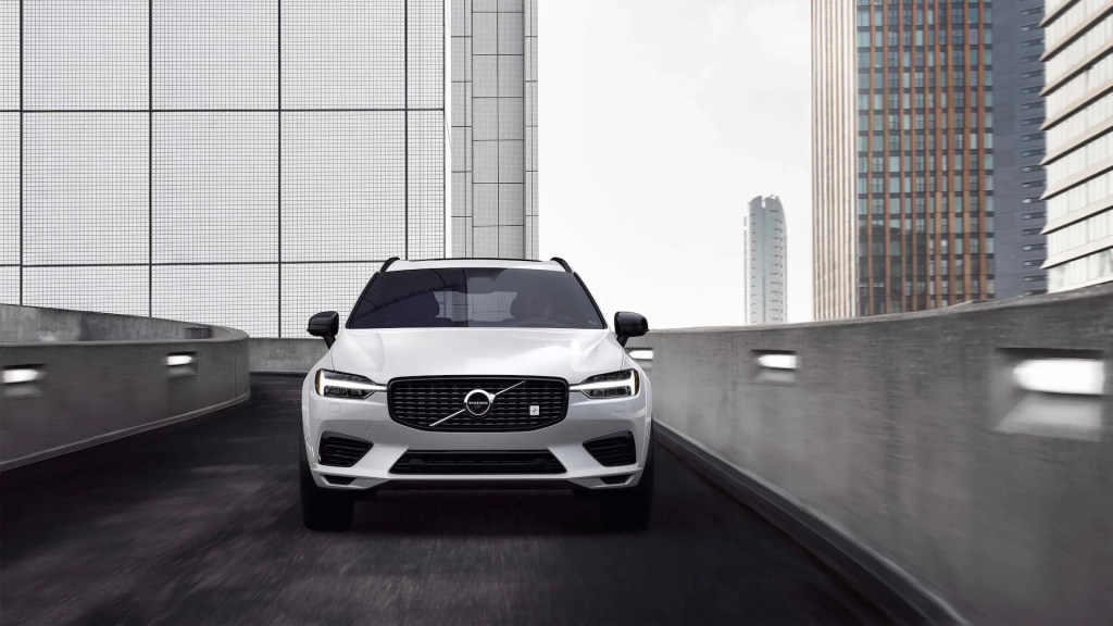 A new Volvo XC60 SUV navigates an urban road as a performance PHEV.