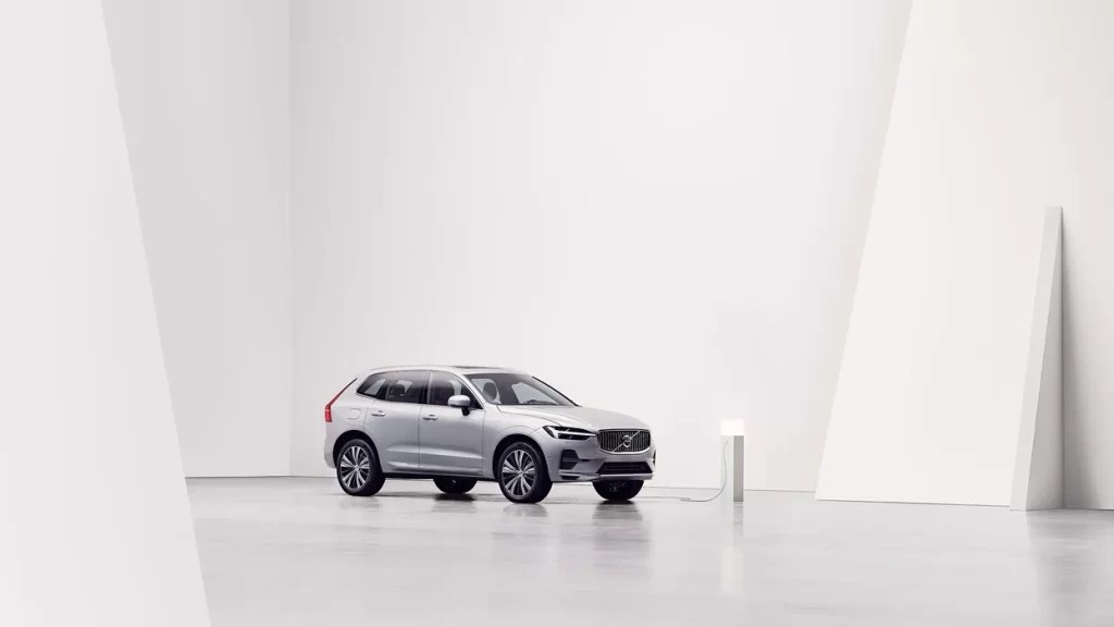 A silver Volvo XC60 Recharge shows off its charging capability as a PHEV SUV, it also has quite a bit of luxury.