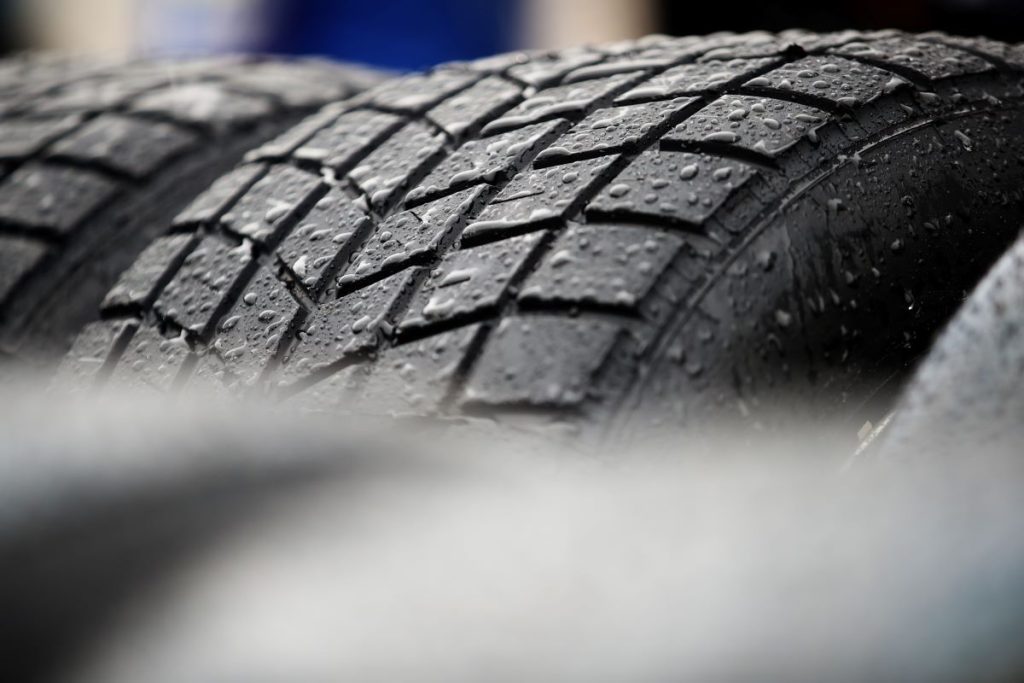 A tire with water on it, possibly all season tires. 