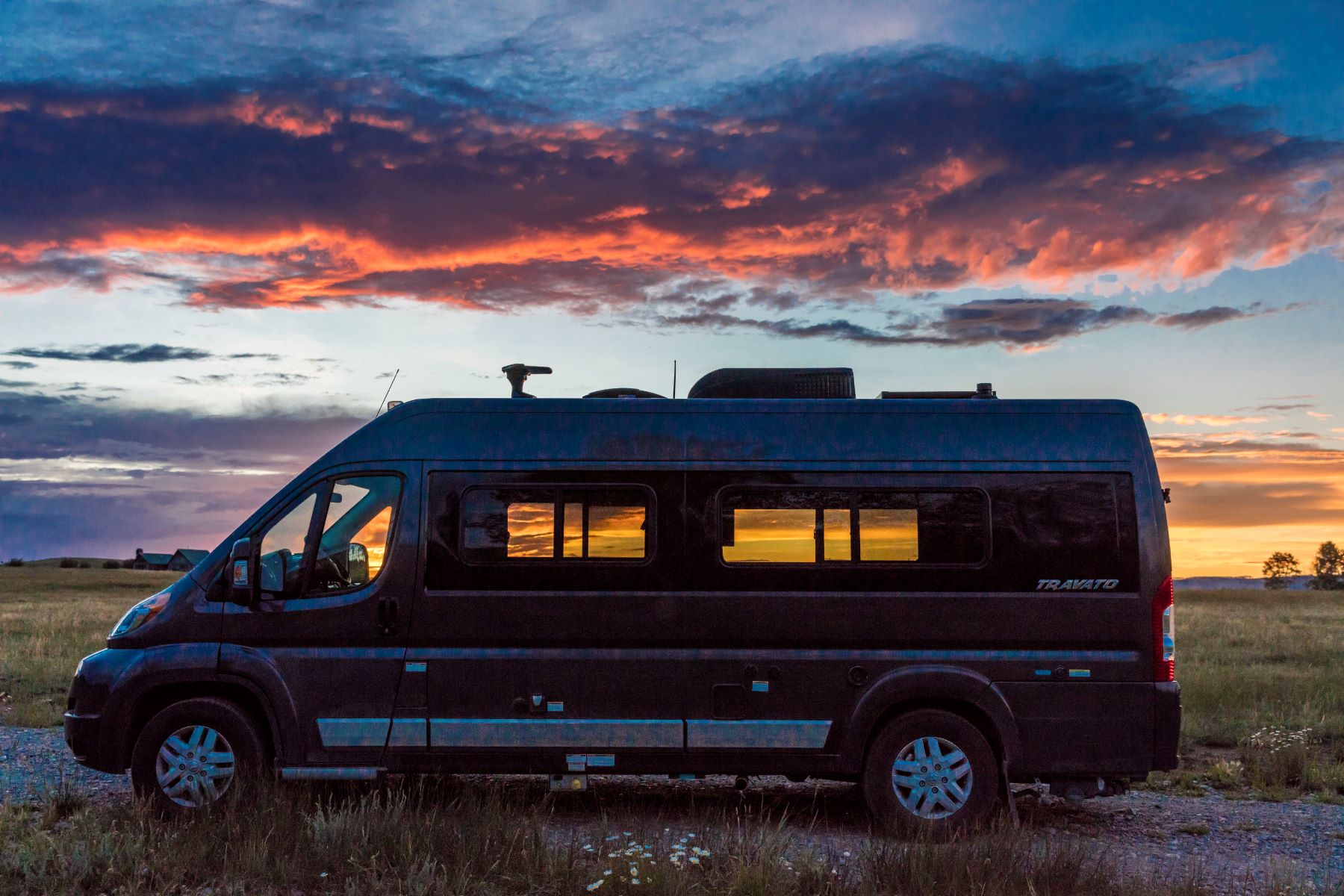 2017 Winnebago Travato camper parked outside during a colorful sunset