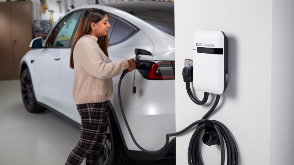 Woman Plugging In Her EV at Home