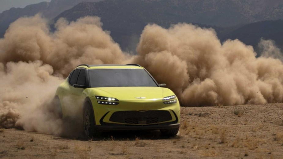 Yellow 2023 Genesis GV60 kicking up some dirt and showing off the fun