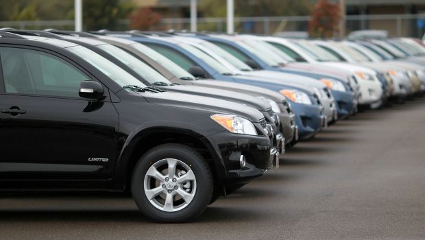 A lineup of Toyota RAV4 SUV models at a Toyota dealership in Oakland, California