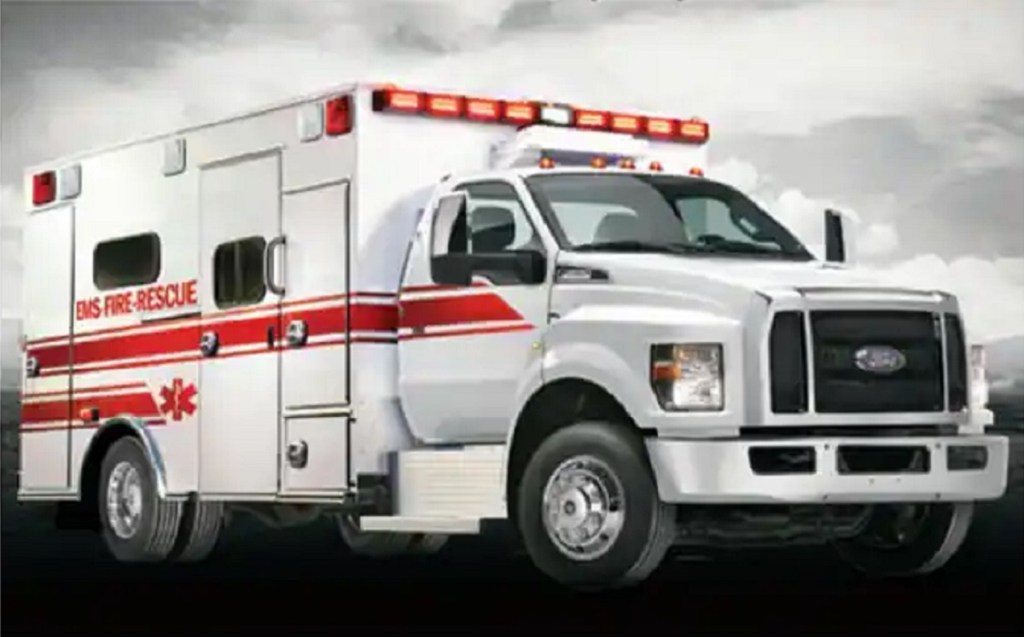 A white ambulance against a gray sky.
