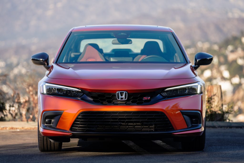 Close-up of the front of a 2022 Honda Civic Si sedan in orange