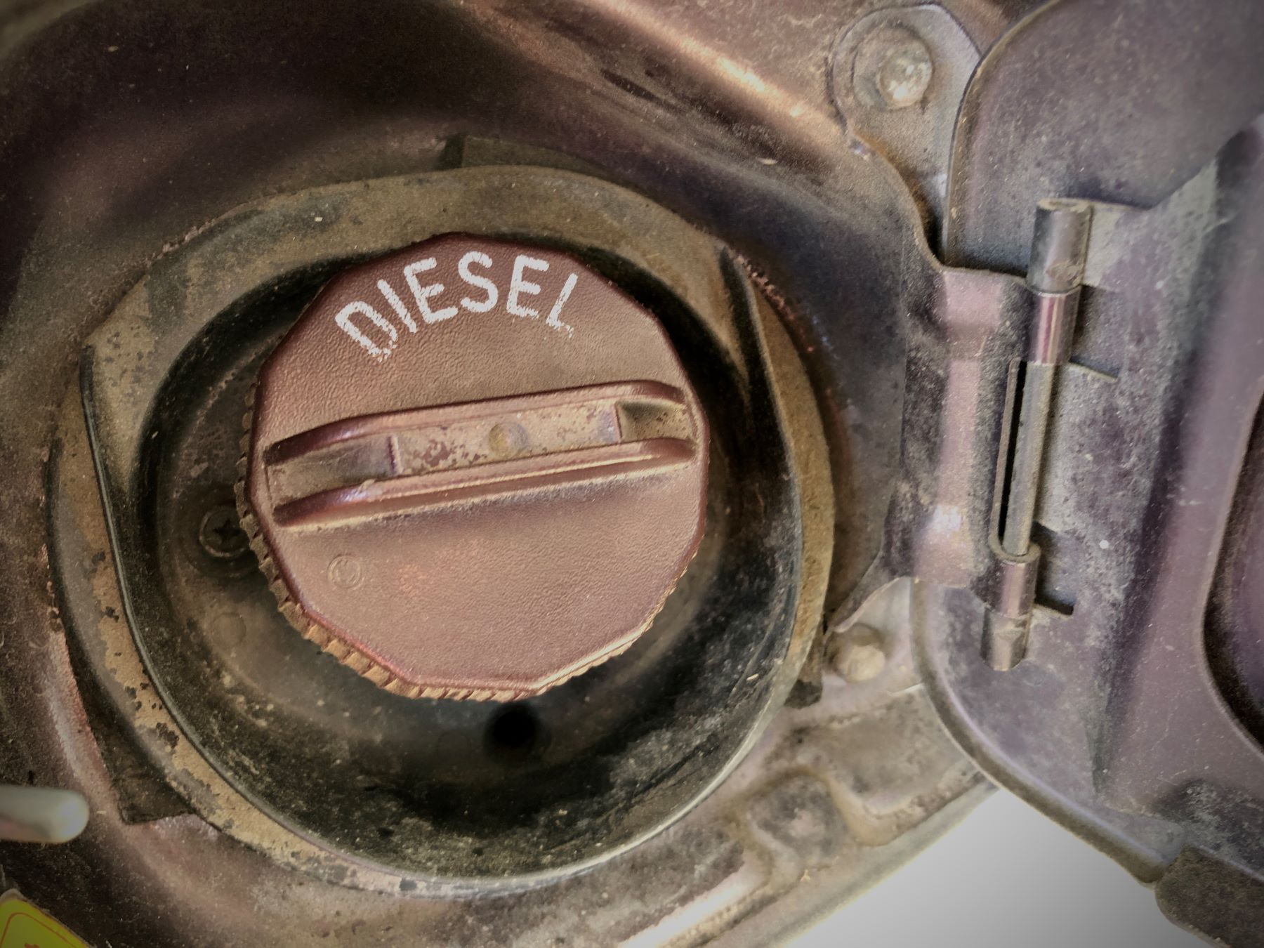 A diesel fuel pump cap on a van parked at a Glastonbury petrol filling station