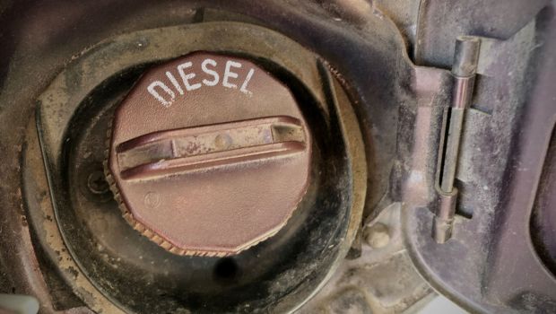 A diesel fuel pump cap on a van parked at a Glastonbury petrol filling station