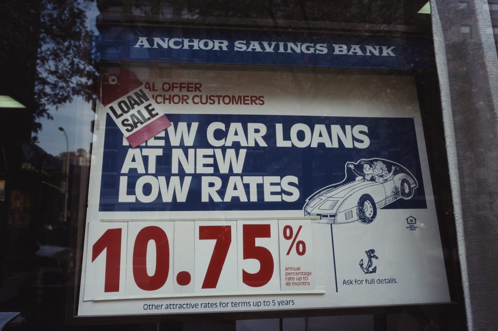 A sign showing finance rates in a window