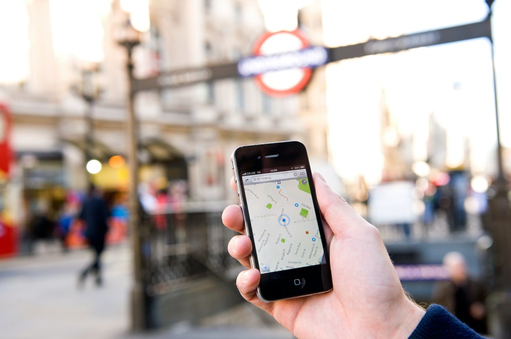 A man using Google Maps on an iPhone
