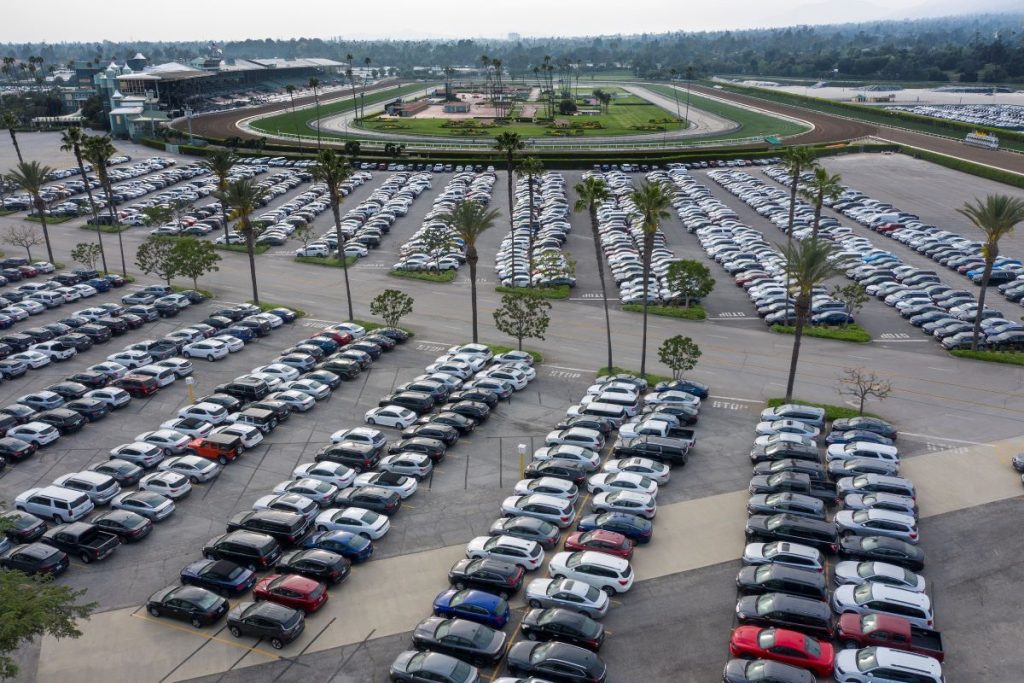 Aerial view of thousands of rental cars in a parking lot