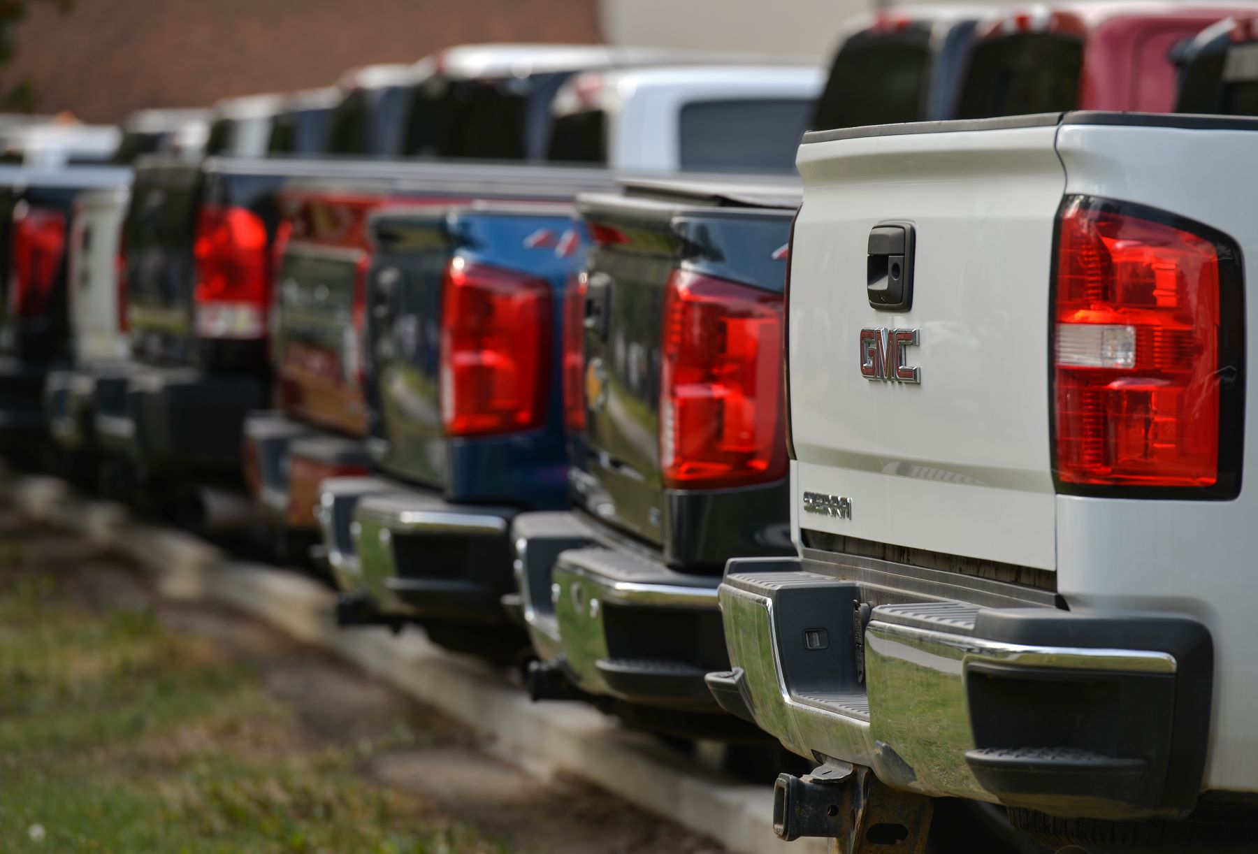 A lineup of GMC pickup truck rear ends and tailgates