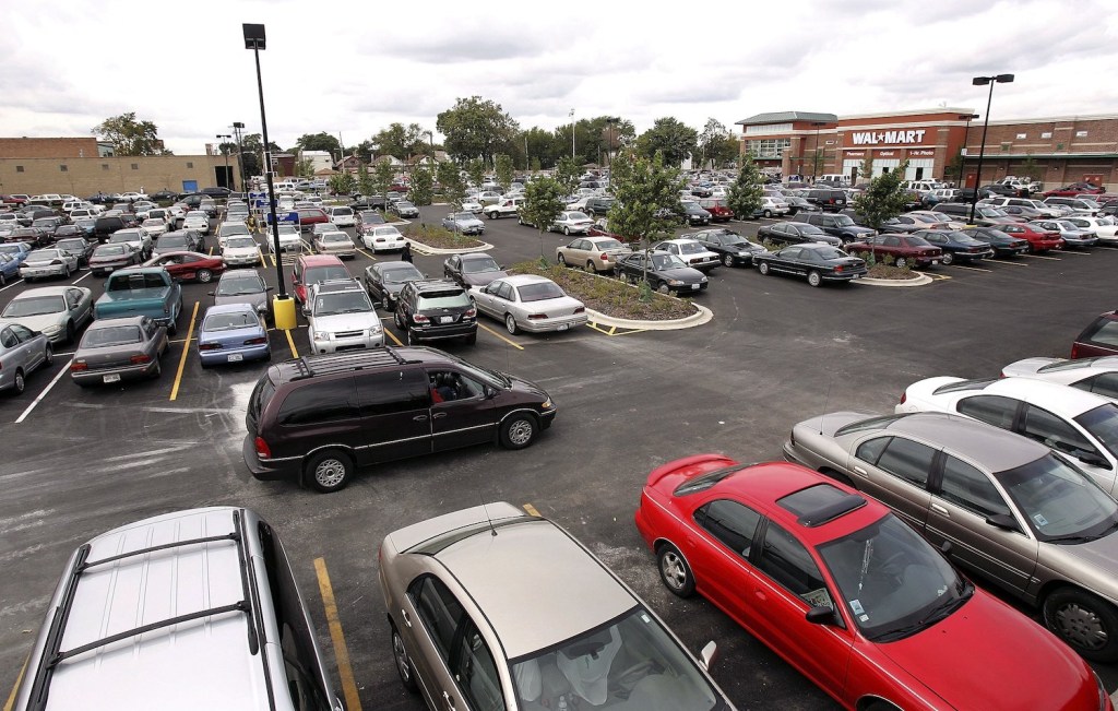 A car drives through a parking lot.