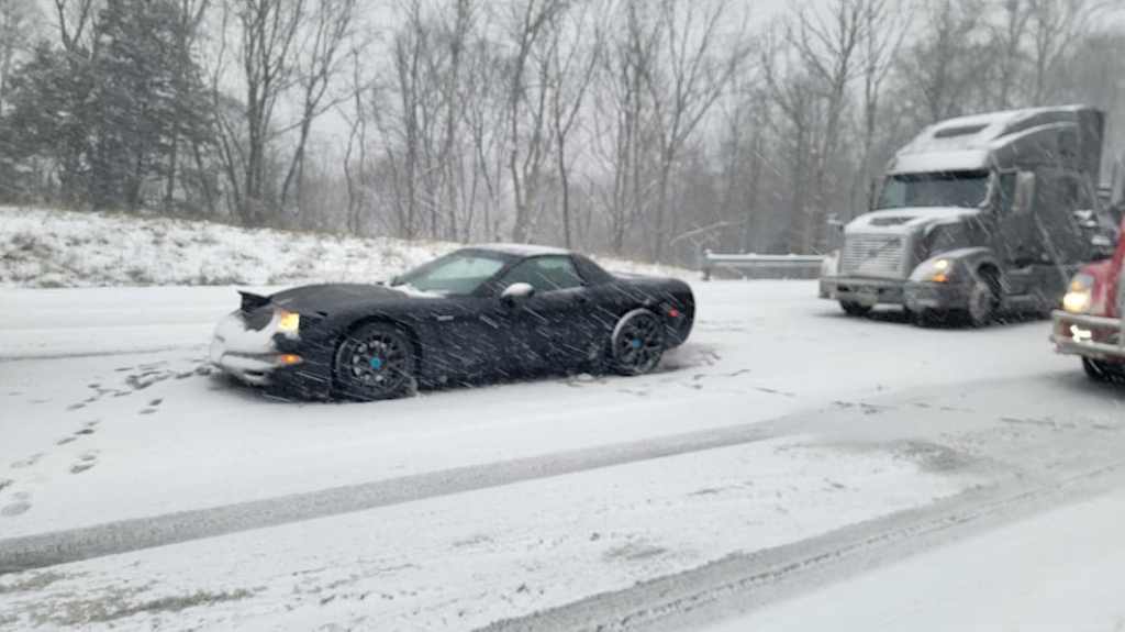 Jonathan Ramsey's Corvette stuck on the side of the snowy highway.