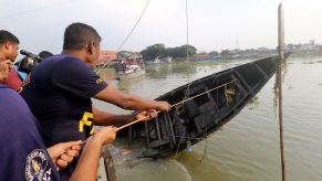 Rescuers retrieving a capsized trawler boat in the Turag river in Dhaka, Bangladesh