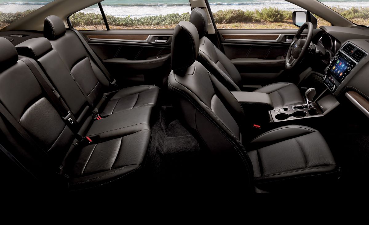Black leather interior of the 2019 Subaru Legacy midsize sedan; the shot is taken from the inside, looking across the front and rear seats at the entire cabin