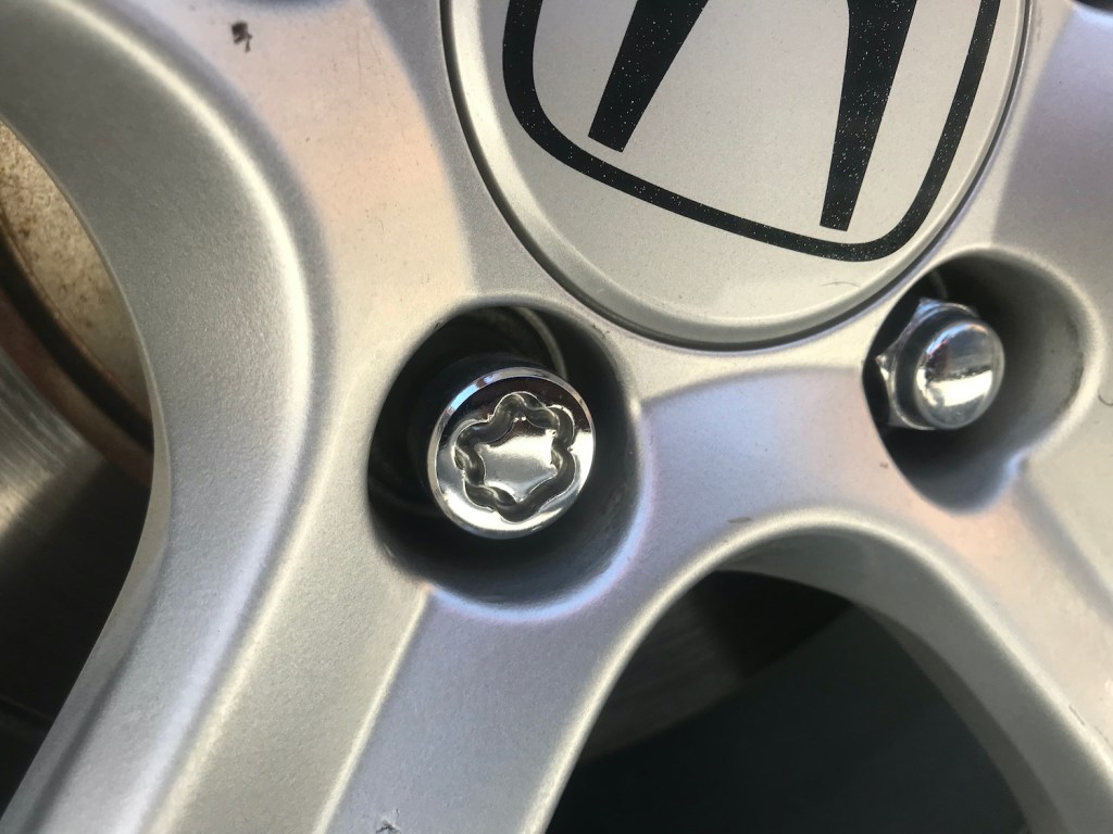 A close up picture of a Honda OEM wheel lock