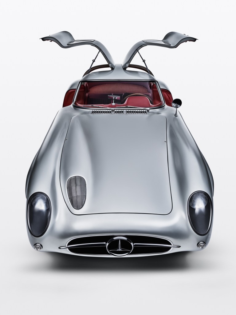 The front view of the silver 1955 Mercedes-Benz 300 SLR Uhlenhaut Coupe with its doors open