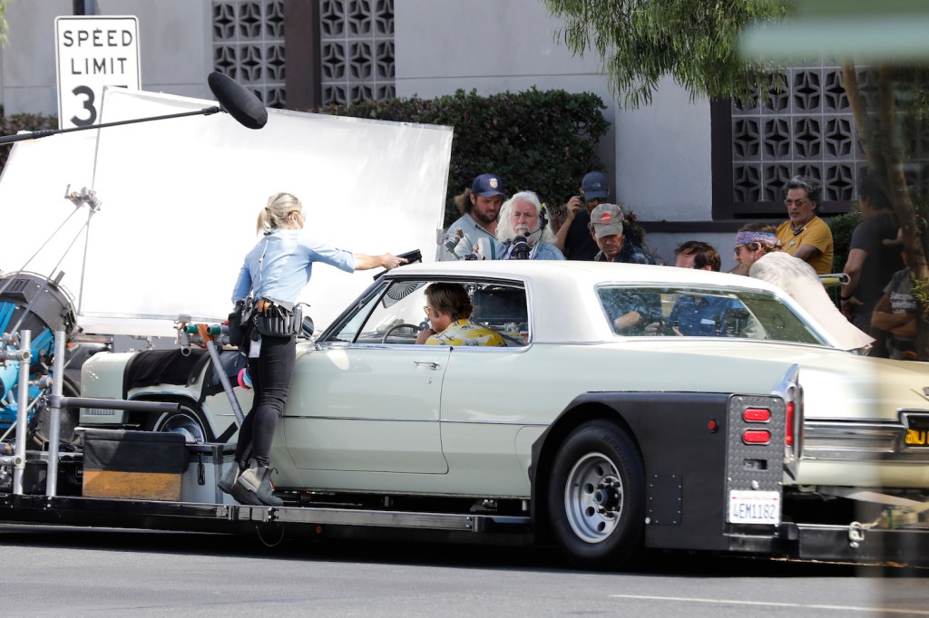 Brad Pitt on a trailer in a 1966 Cadillac Coupe DeVille while filming of 'Once Upon A Time In Hollywood,' directed by Quentin Tarantino.