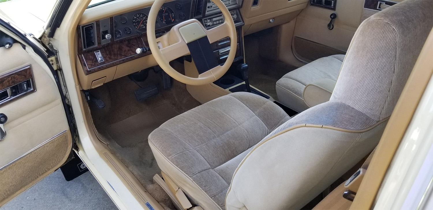 Tan K-car platform interior from a beige 1986 Dodge 600 Coupe , the Cheapest Cars and Bids Auction record holder
