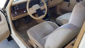 Tan K-car platform interior from a beige 1986 Dodge 600 Coupe , the Cheapest Cars and Bids Auction record holder