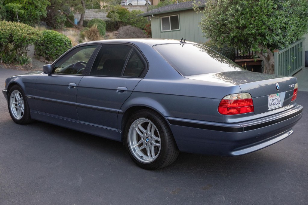 The rear 3/4 view of a gray 2001 E38 BMW 740i M Sport in a California driveway