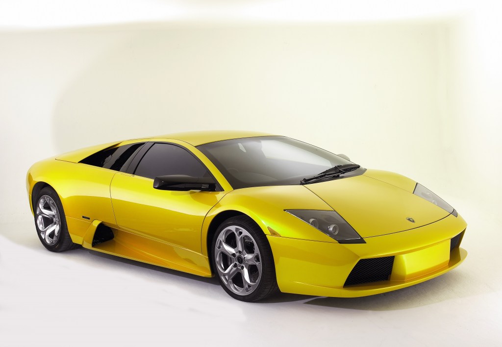 A yellow 2003 Lamborghini Murcielago in a white studio