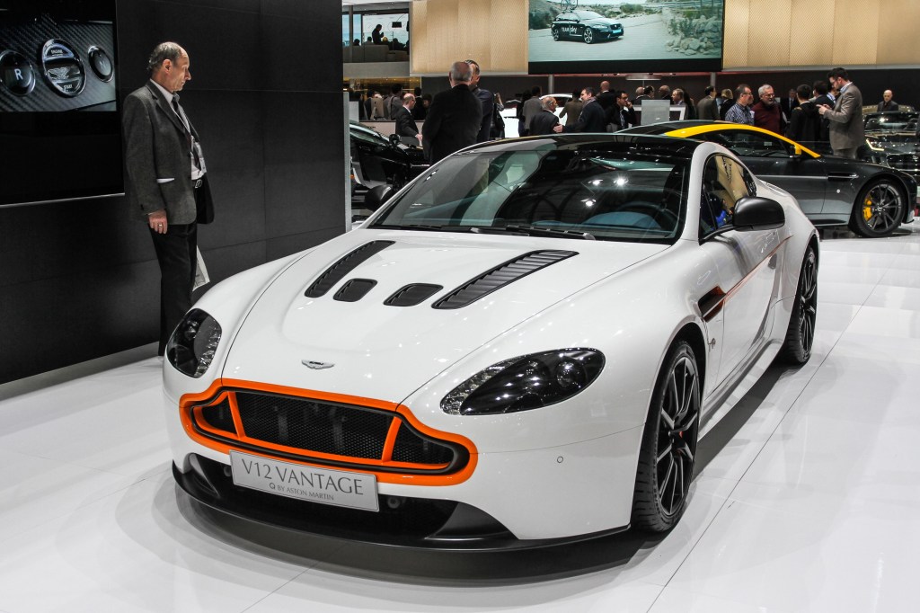 A light-blue 2014 Aston Martin V12 Vantage S with an orange grille at the 2014 Geneva International Motor Show