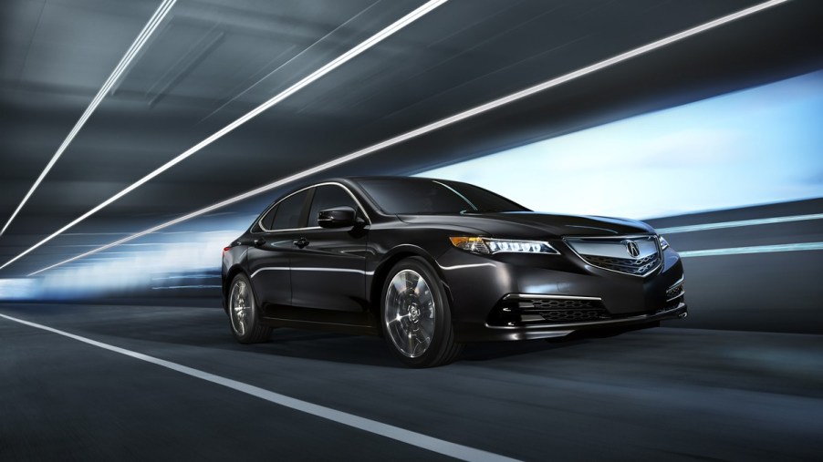 a sporty and luxurious sedan, the 2015 acura tlx drives through a tunnel