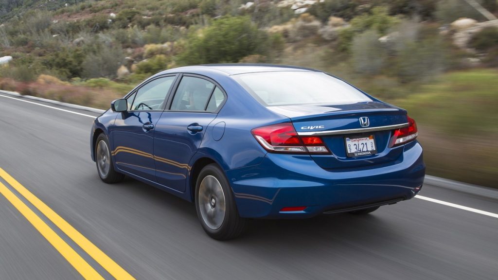a blue 2015 Honda Civic drives down a desert road showing why it's a great compact car under $15,000