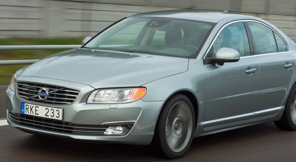 a 2015 volvo s80, a top choice for a used luxury sedan, driving on a road