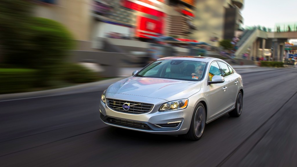 a 2015 volvo s60 drives along a busy city street showing of its prowess as a compact car