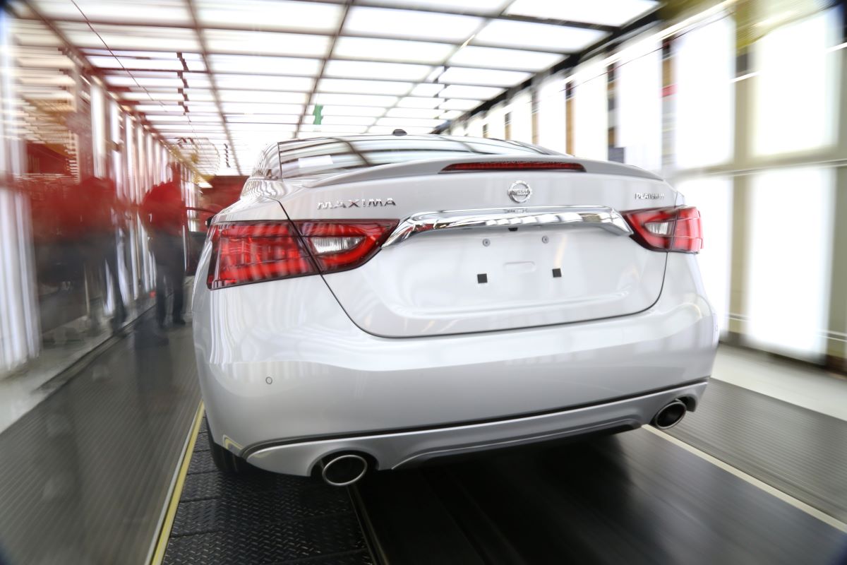 Rear shot of a white 2016 Nissan Maxima coming off the assembly line. This is one of the worst Nissan Maximas to avoid.