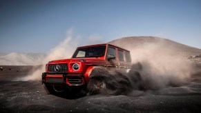 a red g-wagon in the dirt