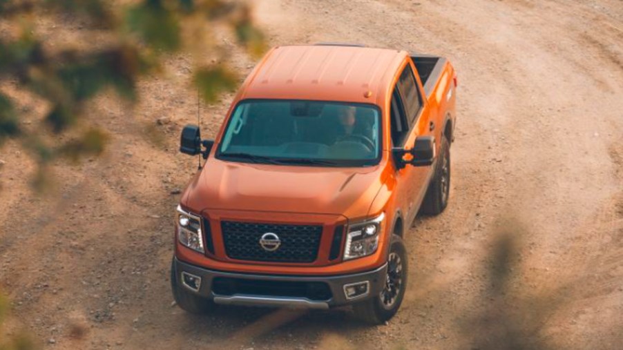 An orange 2019 Nissan Titan Pro 4X is driving off-road.
