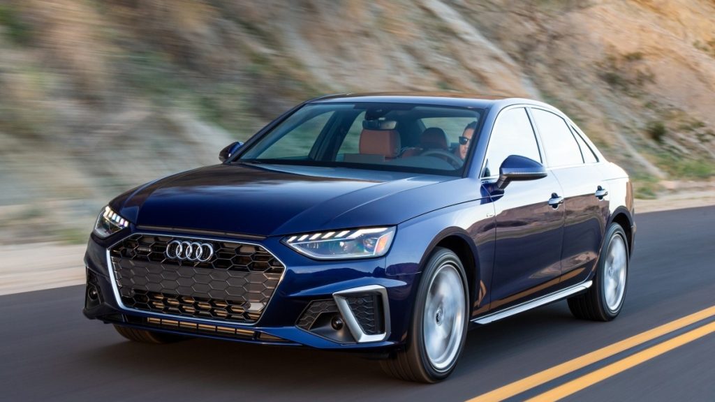 a stylish blue 2019 audi a4 drives along a canyon road utilizing its balanced and luxurious performance