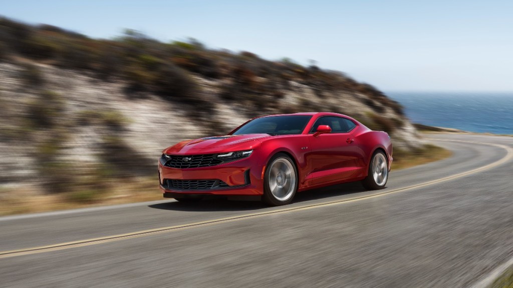 a 2020 chevrolet camaro tackle a curvy road along the ocean