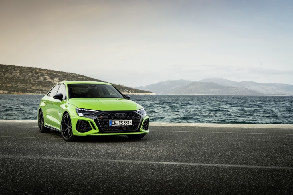 A bright-green 2022 Audi RS3 by the ocean