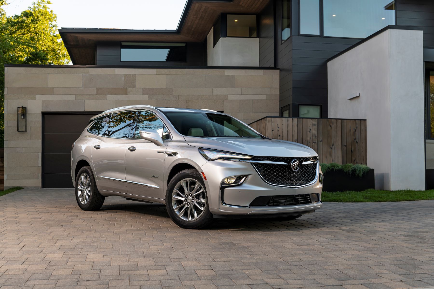 A 2022 Buick Enclave crossover SUV parked on a cobblestone brick garage driveway