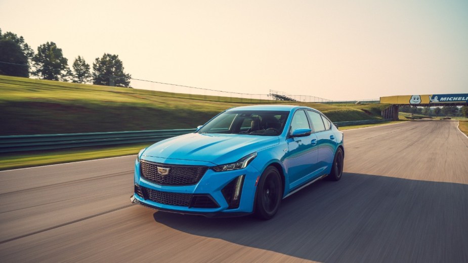 a blue 2022 cadillac ct5-v blackwing on track, a new car that comes with a supercharger