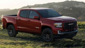 A red 2022 GMC Canyon in front of the mountains.