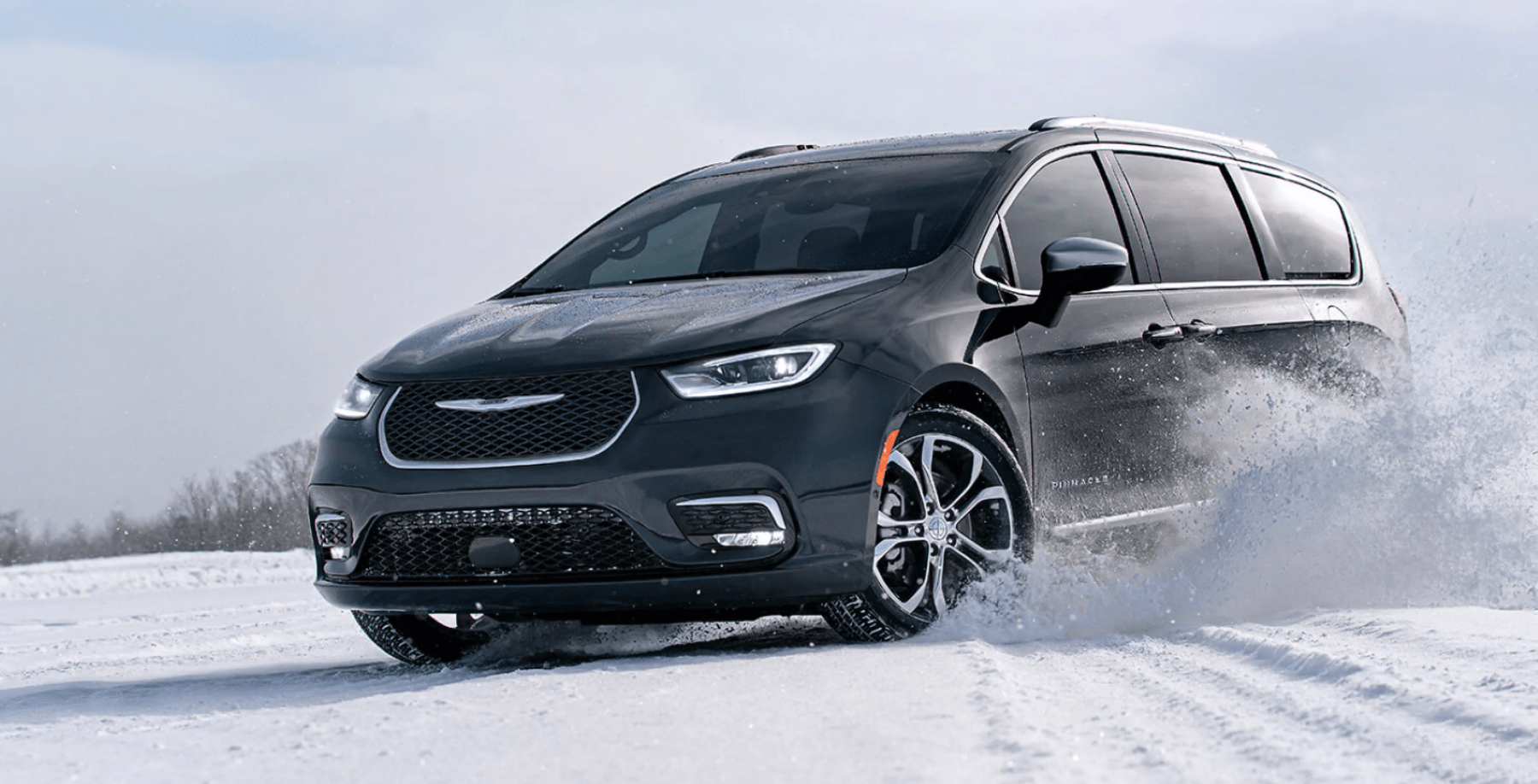 2022 Chrysler Pacifica Pinnacle minivan with all-wheel drive (AWD) driving through off-road snow