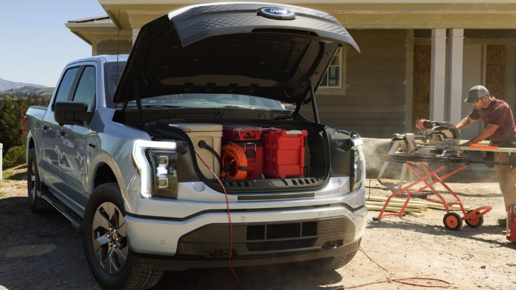 2022 Ford F-150 Lightning with the hood up and the Mega Power Frunk filled with useful gear.