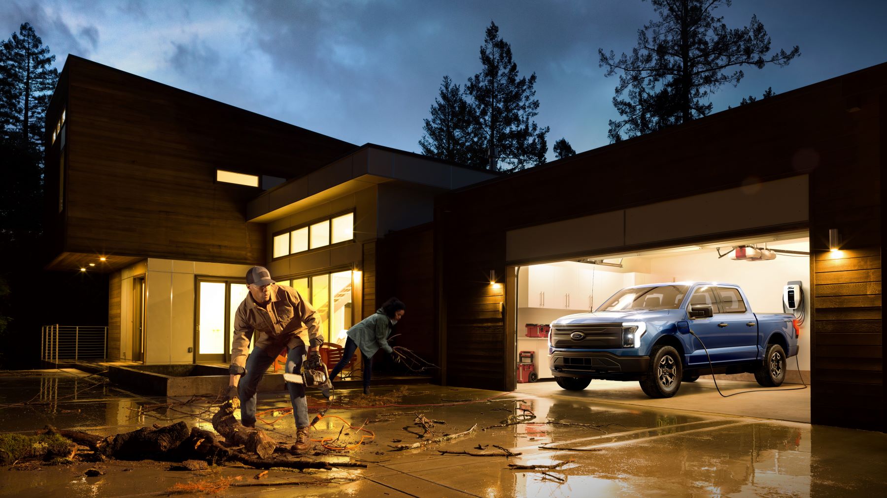 A 2022 Ford F-150 Lightning Pro all-electric pickup truck installed and charging in the garage