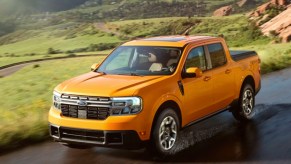 A yellow 2022 Ford Maverick small pickup truck is driving on the road.